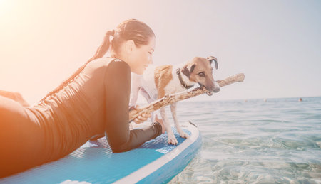 Woman Dog Paddleboard - Woman and dog enjoying paddleboarding on a sunny day.の写真素材