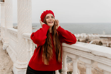 Woman Red Beret Smiling Ocean View Balcony Happinessの写真素材