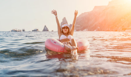 Woman floating sea, young female relaxing on inflatable ring in ocean during summer vacation with...