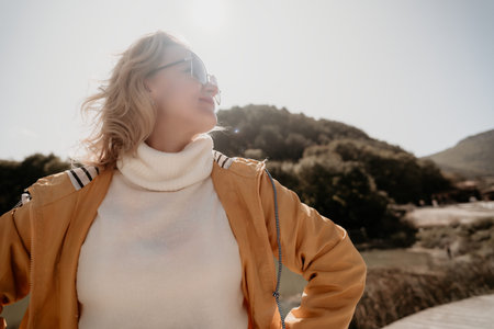 Woman in a Yellow Jacket, Looking Up with Hope