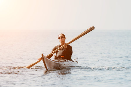 Kayaking Ocean Sunset Paddle - Person kayaking in the ocean at sunset.の写真素材