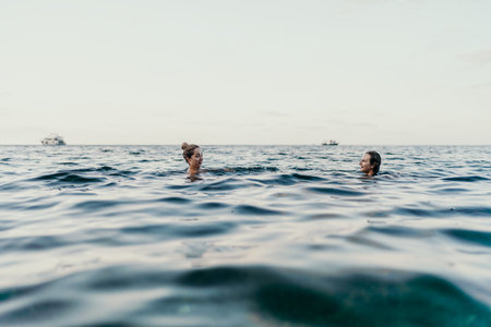 Swimming ocean women happily enjoying a tropical vacation in clear blue water with copy space