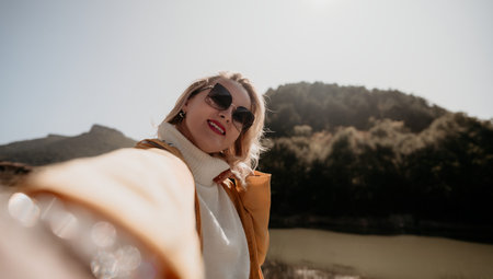 Selfie with a View: Blonde Woman in Yellow Jacket