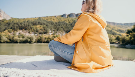 Woman in Yellow Jacket Contemplating Nature