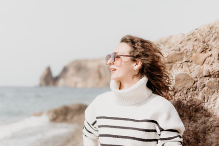 Woman portrait coastline smiling female in striped sweater and sunglasses enjoying sea view on a...