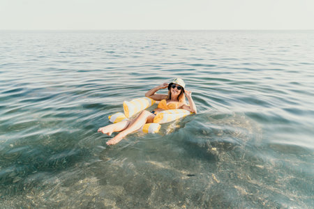 Woman Inflatable Chair Sea Relaxing - A woman relaxes on an inflatable chair in the sea.
