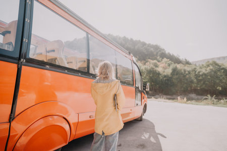 Woman in Yellow Jacket Waiting at a Bus Stop