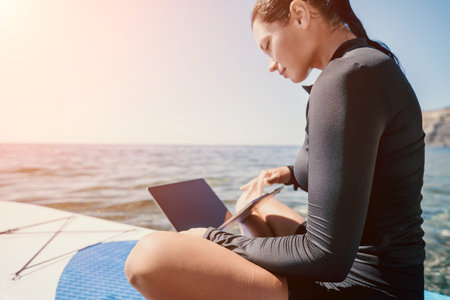 Woman Laptop Beach Working Remotely on a Paddleboard