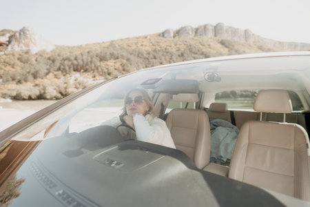 Woman Driving a Car Through a Mountain Pass