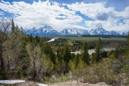 Grand Tetons reflected in still water of the Snake River at Oxbow Bend.の写真素材