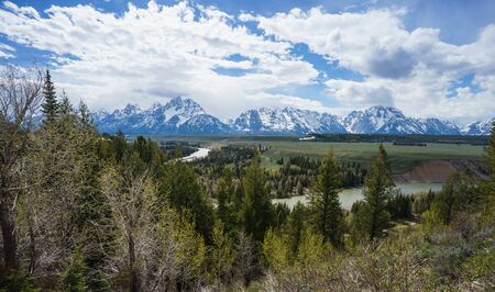 Grand Tetons reflected in still water of the Snake River at Oxbow Bend.の写真素材