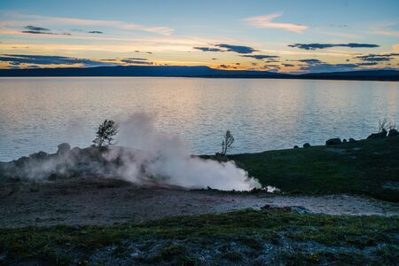 Beautiful Sunset Scenery at a lake in the Yellowstone national park, Wyomingの写真素材