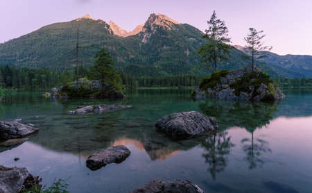 Beautiful scene of trees on a rock island and mountains at sunset time in summer, Lake Hintersee National park Berchtesgadener Land, Upper Bavaria, Germany, Europeの写真素材