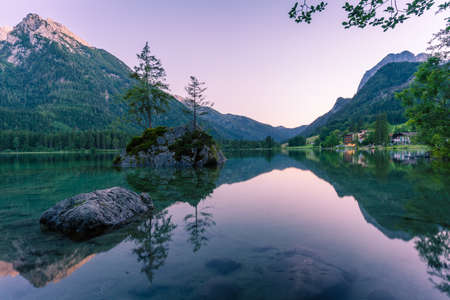 Beautiful scene of trees on a rock island and mountains at sunset time in summer, Lake Hintersee National park Berchtesgadener Land, Upper Bavaria, Germany, Europeの写真素材