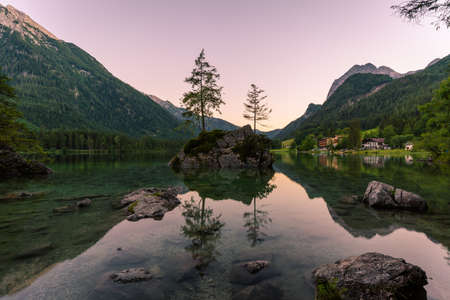 Beautiful scene of trees on a rock island and mountains at sunset time in summer, Lake Hintersee National park Berchtesgadener Land, Upper Bavaria, Germany, Europeの写真素材
