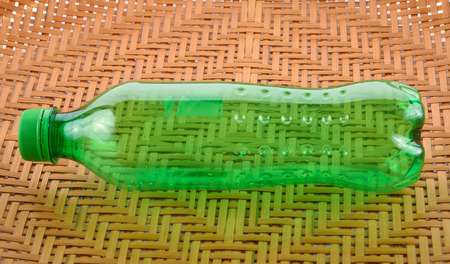 Drinking water bottles on a wooden floor backgroundの写真素材