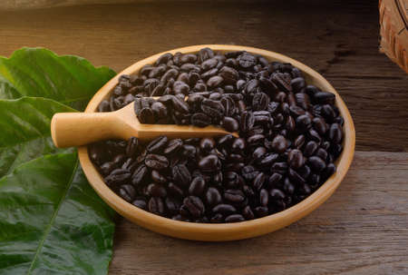 The light that hits the coffee beans on the wooden backgroundの写真素材