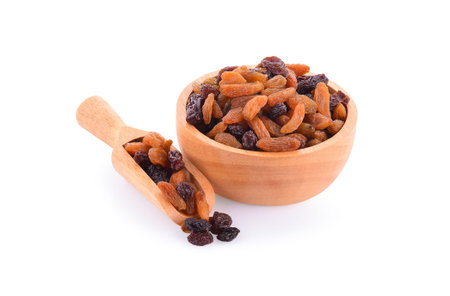 raisins in bowl isolated on white backgroundの写真素材