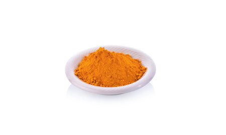 turmeric powder in a bowl isolated on white background