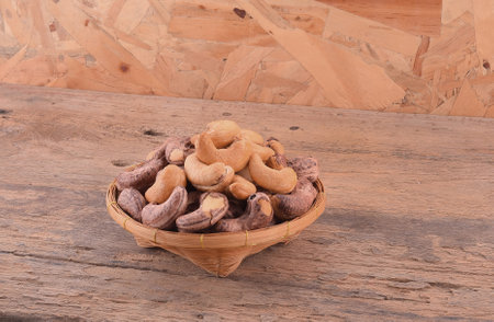 cashew nuts in basket on wooden backgroundの写真素材