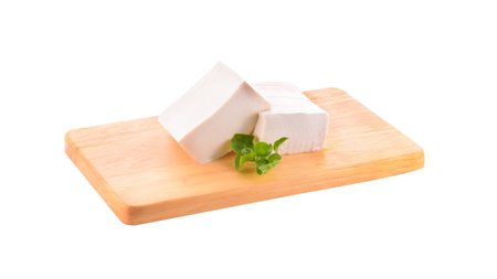 tofu on chopping board isolated on white backgroundの写真素材
