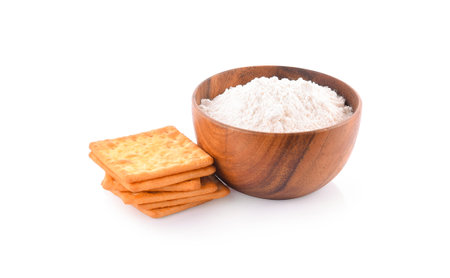 Wheat flour in wooden bowl and biscuits isolated on white background.の写真素材