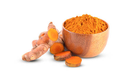 fresh turmeric herbs and turmeric powder in bowl on white backgroundの写真素材