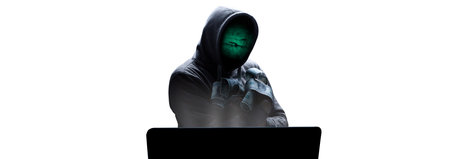 Hacker prints a code on a laptop keyboard to break into a cyberspaceの写真素材