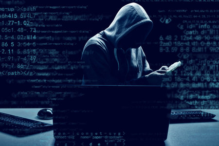 Hacker prints a code on a laptop keyboard to break into a cyberspace