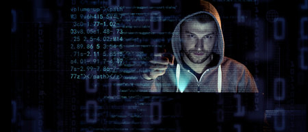 Hacker prints a code on a laptop keyboard to break into a cyberspace
