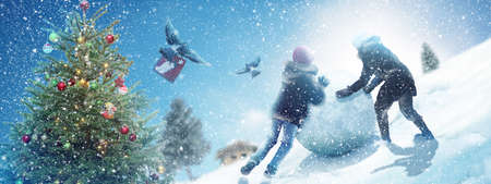 Happy snowman standing in winter christmas landscape.の写真素材