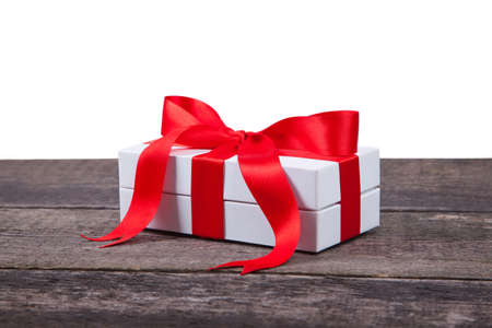 Gift box in wrapping paper with satin ribbon. Merry Christmas holiday concept.の写真素材