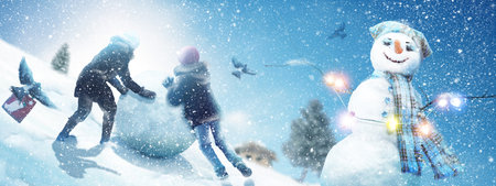 Happy snowman standing in winter christmas landscape.の写真素材