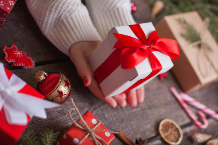 Gift box in wrapping paper with satin ribbon. Merry Christmas holiday concept.の写真素材