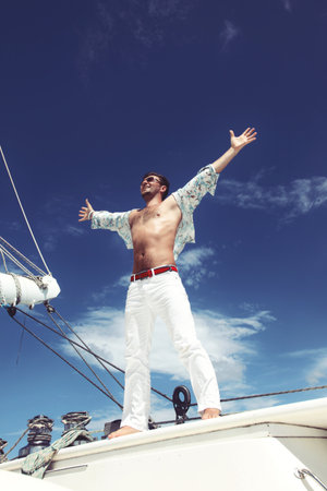 Man enjoying summer time holiday on sailing boat.の写真素材
