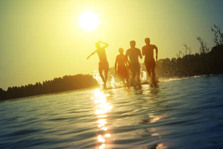 Group of young people playing games on sandy beach on a summer day.の写真素材