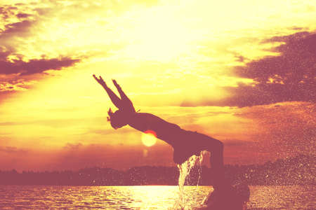Group of young people playing games on sandy beach on a summer day.の写真素材