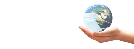 COVID-19, travel and safe world concept, globe in medical mask. Planet Earth with protect.