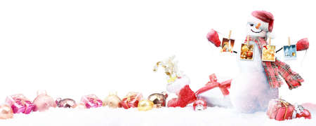 Happy snowman standing in winter christmas landscape.の写真素材