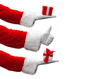 Santa holding a gift. Merry Christmas composition concept.の写真素材