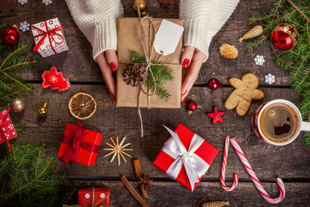 Gift box in wrapping paper with satin ribbon. Merry Christmas holiday concept.の写真素材