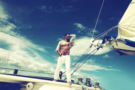 Man enjoying summer time holiday on sailing boat.の写真素材