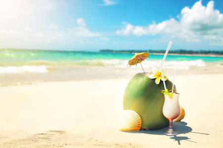 Sandy tropical beach with summer drinks. Holiday background.の写真素材