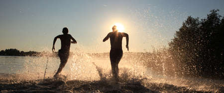Group of young people playing games on sandy beach on a summer day.の写真素材