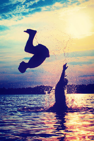 Group of young people playing games on sandy beach on a summer day.の写真素材