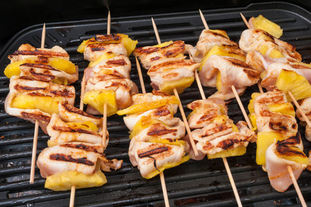 Chicken shish kebab with pineapples on grilの写真素材