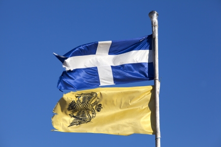 Greek and Byzantine flags under blue sky isolatedの写真素材