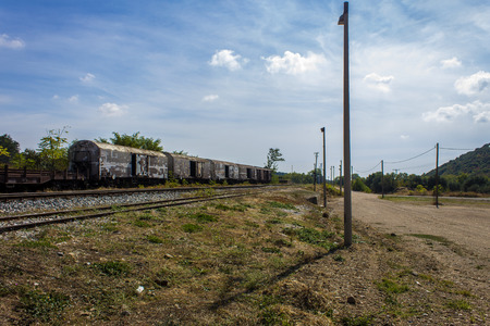Train on abandoned railway under blue sky and with natural lightの写真素材