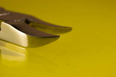 Tools, scissors for manicure on a yellow background, top view. Nail tool, macro photography.の写真素材