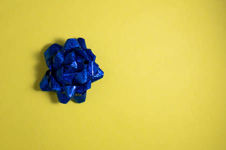 Top View of Gift Bow on Yellow Background with Copy Space. Holiday and Gift concept.の写真素材
